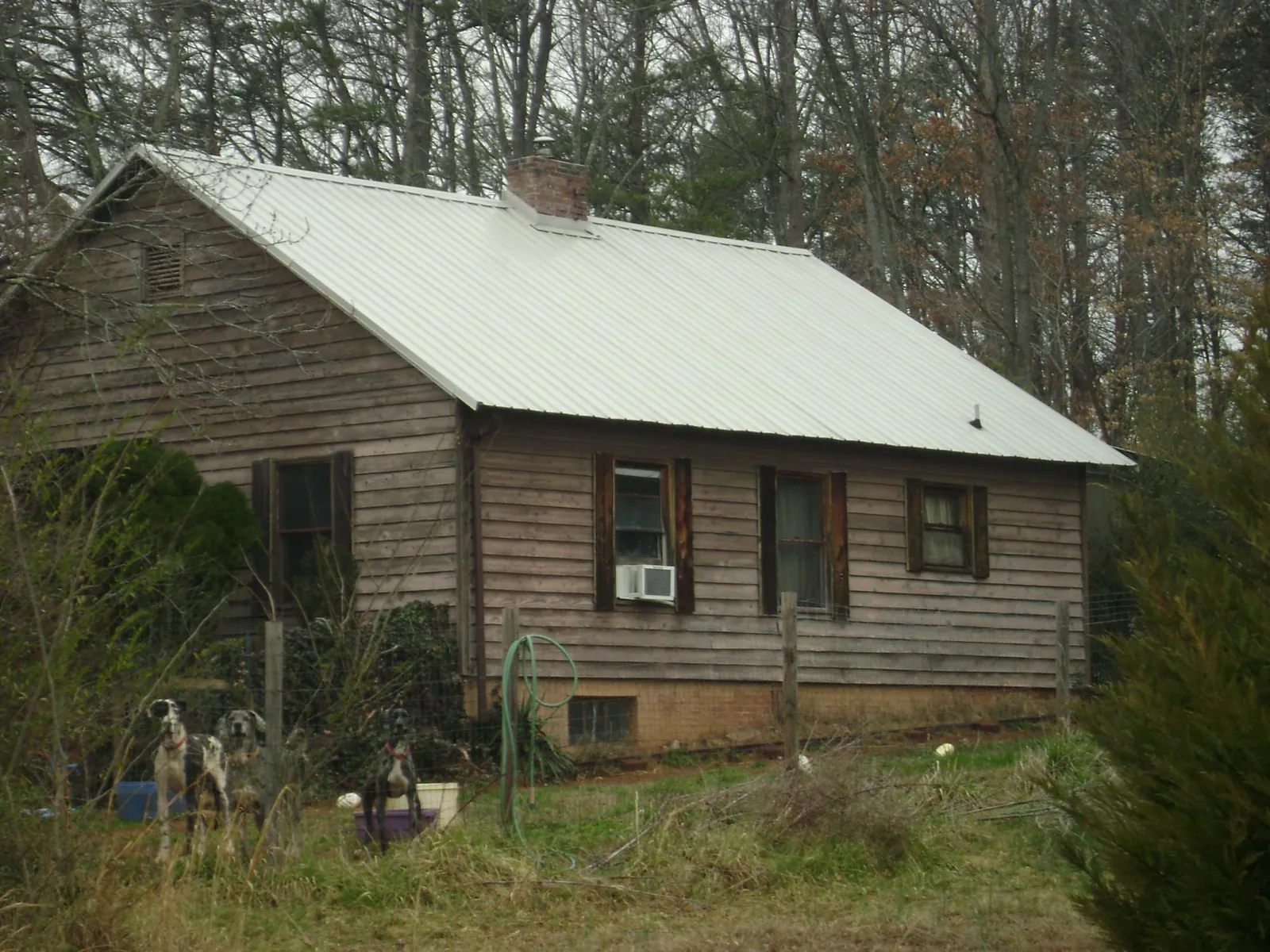 White metal roof on an old wood sided farmhouse, from a Metal Roof Installation job in Middlesex